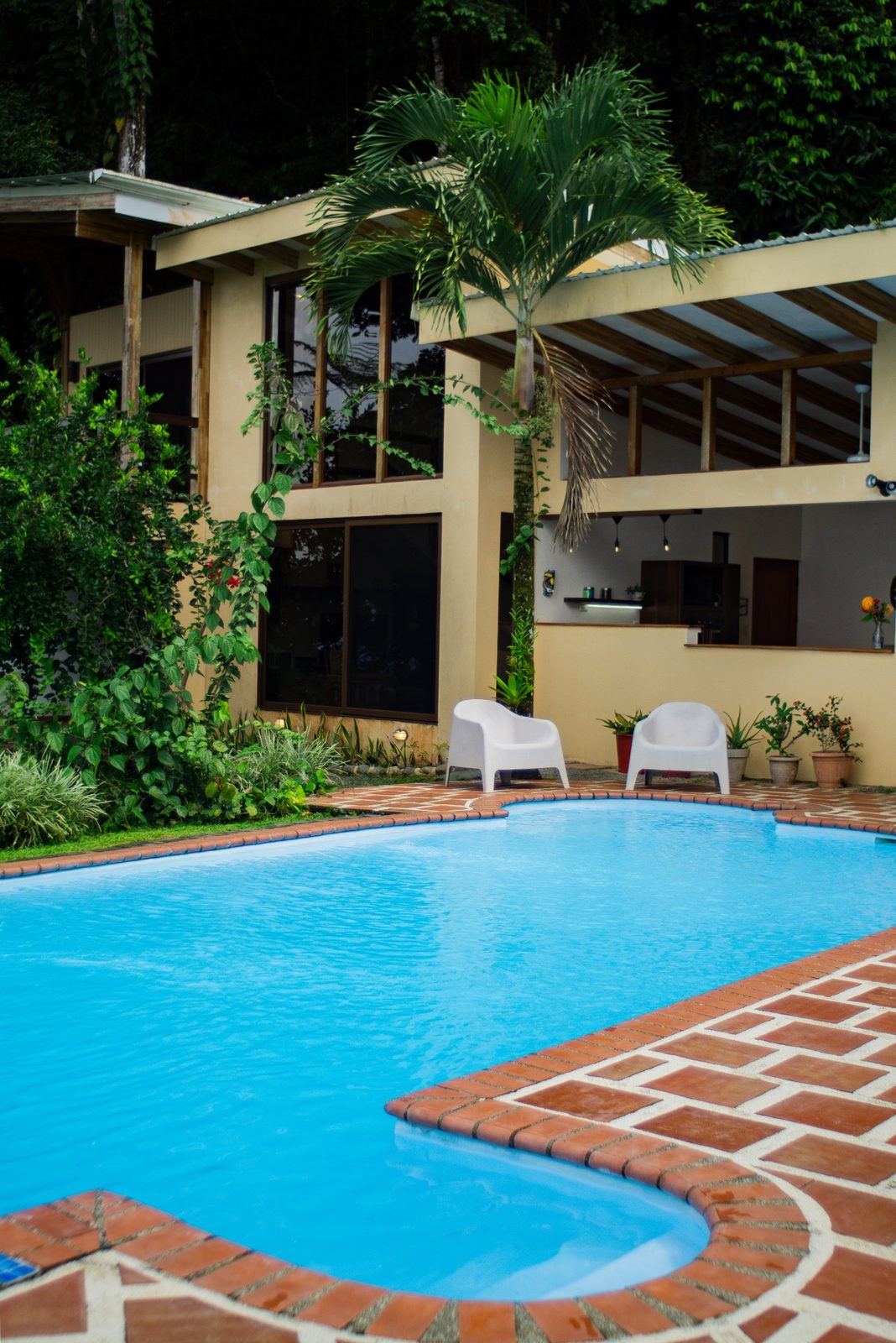 Turquoise pool in front of the two-story villa