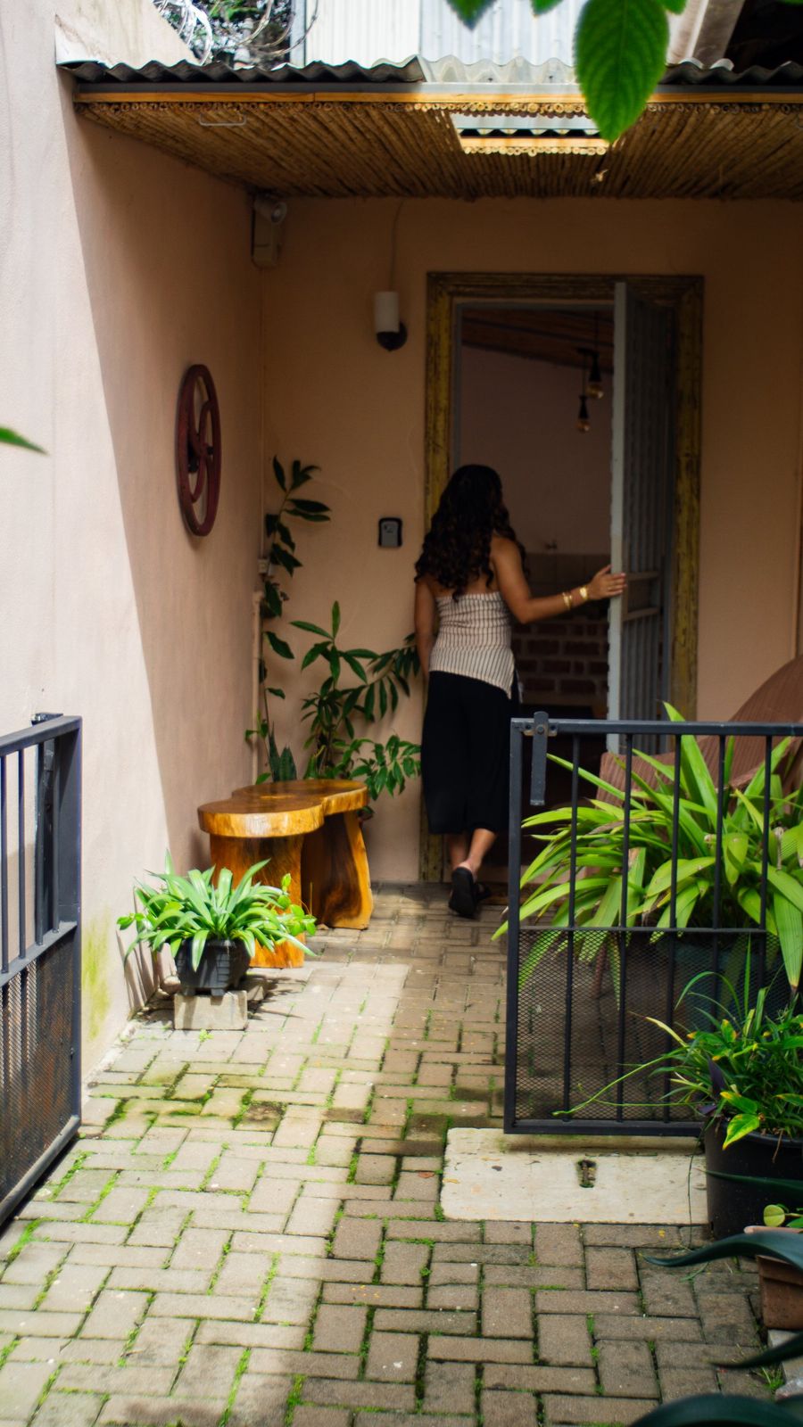 Guest stepping through the doorway off the brick courtyard