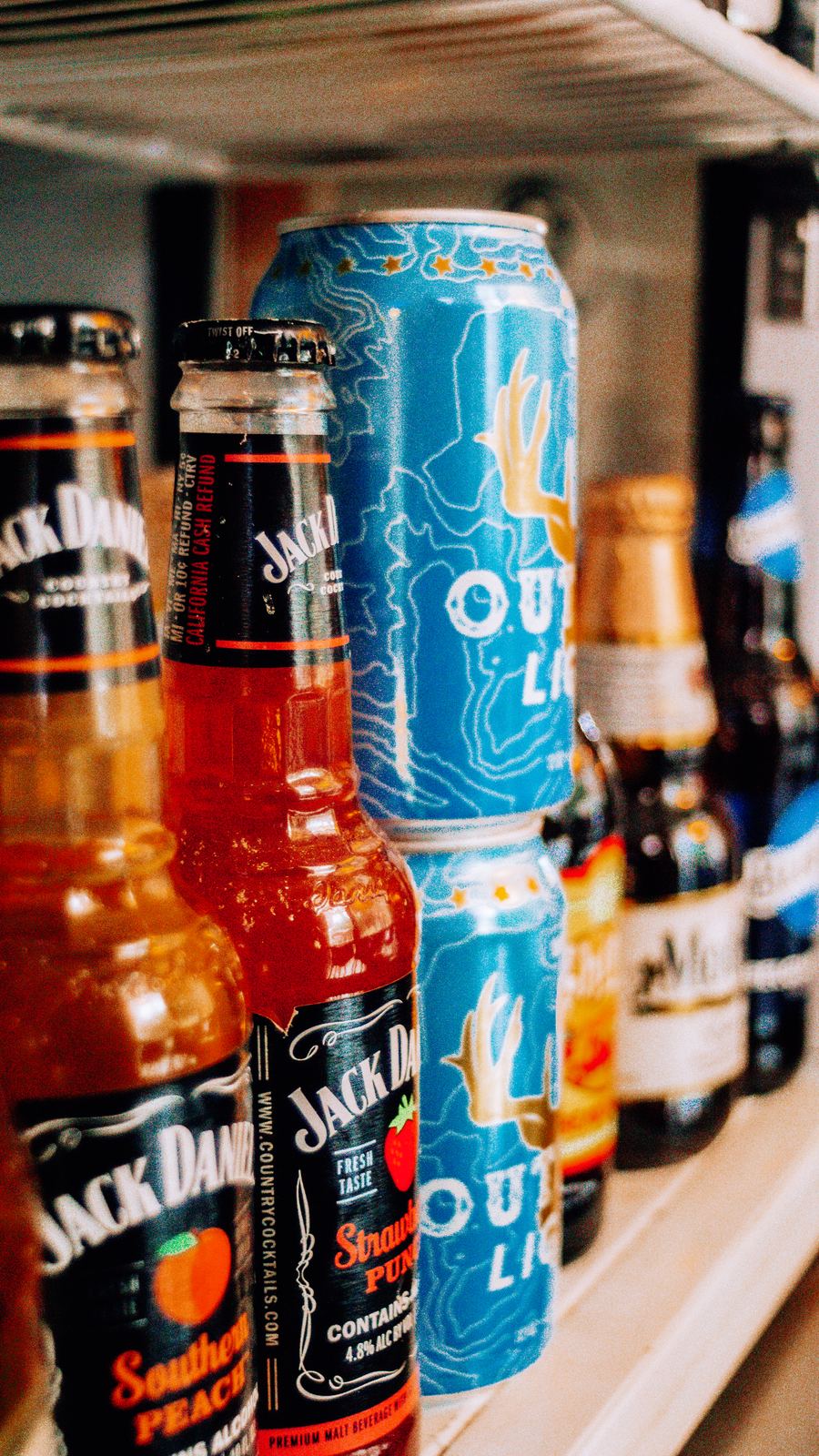Bottled and canned drinks lined up in the cooler